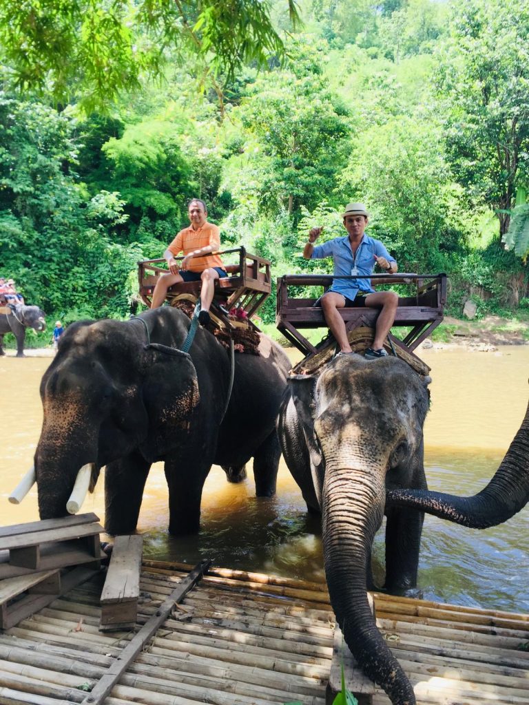 Phil riding an elephant